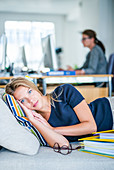 Woman taking a nap in the office