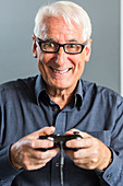 Senior man playing videogames