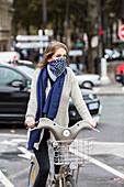 Woman riding a bicycle in a urban environment