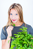 Woman inhaling lemon balm fragrance