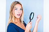 Woman using a magnifying glass