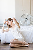 Woman in front of electric fan