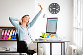 Office woman stretching arms at work