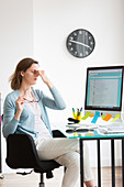 Woman at work suffering from headache