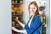 Woman in front of a refrigerator
