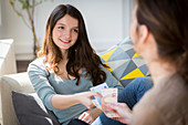 Mother giving her daughter pocket money