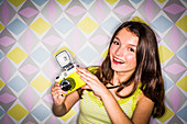 Teenage girl using a camera