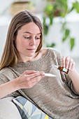 Woman applying essential oil on a tissue