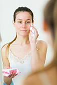Woman using make-up remover