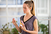 Woman holding oral contraception pills