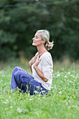 Senior woman practicing respiratory exercises