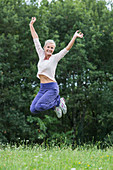 Woman jumping on grass