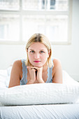 Young woman lying in bed