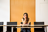 Woman alone in a conference room