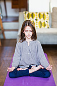 8 year-old girl practicing relaxation exercises