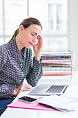 Woman at work suffering from headache