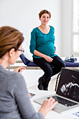 Pregnant woman in consultation with a doctor