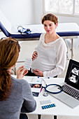 Pregnant woman in consultation with a gynaecologist