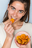 Woman eating dry apricot