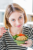 Woman eating a quinoa salad