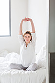 Woman waking up and stretching
