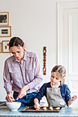 6 year-old girl learning cooking with her mother