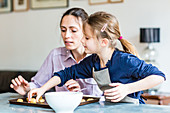 6 year-old girl learning cooking with her mother