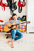 Teenage girl playing guitar