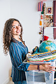 Teenage girl organizing her bedroom