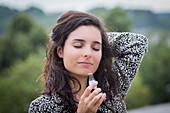 Woman smelling essential oil