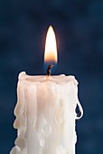 Lit candle with melted wax