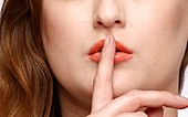 Woman with finger to her lips
