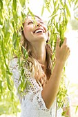 Woman touching green leaves