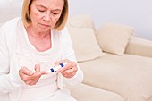 Woman testing glucose