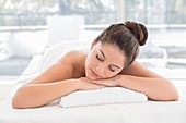 Woman lying on towel in spa