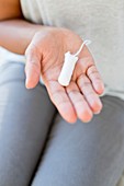 Woman holding tampon
