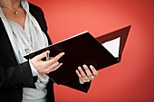 Businesswoman holding black folder