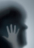 Silhouette of person's head and hand