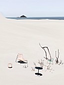 Garden furniture in a lonely hallway in the sand by the sea