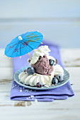 Meringues with blueberry ice cream and a cocktail umbrella