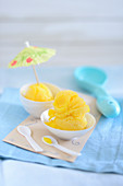 Mango sorbet with a cocktail umbrella