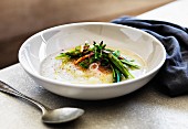 White turnip soup with asparagus and pine nuts