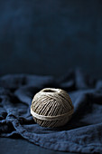Ball of string on blue fabric