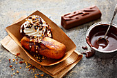 Deep-fried chocolate bars with whipped cream and brittle