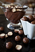 Bowls of chocolate pudding topped with chocolate covered cookies