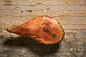 A stamped leg of farmhouse ham on a wooden background