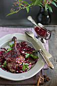 A duck leg on a bed of radicchio