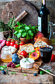 Cheese, fruit, tomatoes, bread, honey and red wine