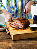 Grilled beef brisket being cut into slices