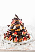 Profiterole pyramid cake with strawberries